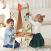 Kids wooden art easel storage tray close-up with paint cups markers and art supplies