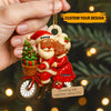 Personalized Christmas ornament with Santa and a woman on a bike, against a festive background.