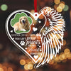 Heart-shaped ornament with a dog's photo, angel wings, and text on a blurred background