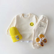 Adorable conjunto de chándal para bebé con estampado de caritas sonrientes 
